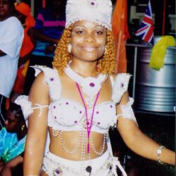 Smiling woman in white beaded carnival costume