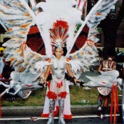 Carnival dancer in silver and red feathered costume