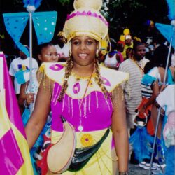 Woman in bright pink and yellow carnival costume