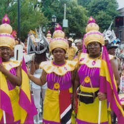 Group in colorful pink and yellow carnival costumes