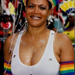 Smiling woman in rainbow costume at carnival