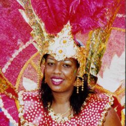 Smiling woman in pink feathered carnival costume