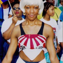 Smiling woman in white wig at parade