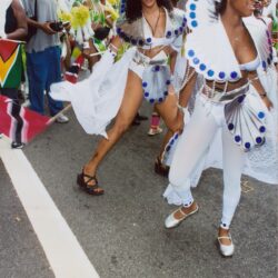 Women dancing in white feathered carnival costumes