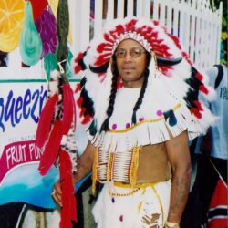 Man wearing feathered headdress and costume