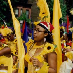 Carnival performer in yellow costume with sunflowers