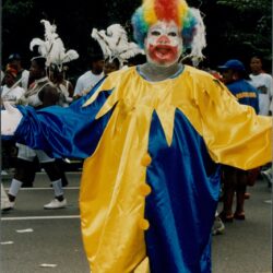 Colorful clown with rainbow wig at parade