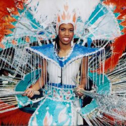 Carnival performer in blue feathered costume