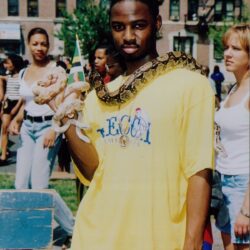 Man with snake draped over his shoulders