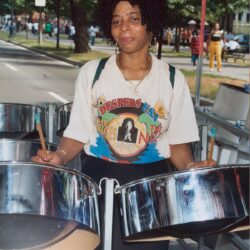 Woman playing steel drums at outdoor festival