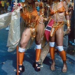 Two dancers in orange carnival costumes
