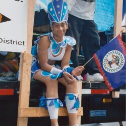Person in blue costume sitting on float.