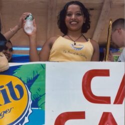 Smiling woman holding a drink bottle.