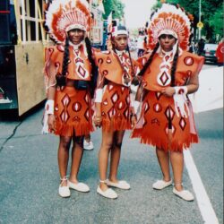 Three people in decorative red costumes.