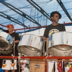 Musicians playing steel drums on stage.