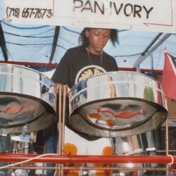 Person playing steel drums at event.