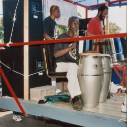 Musicians playing drums on a parade float.
