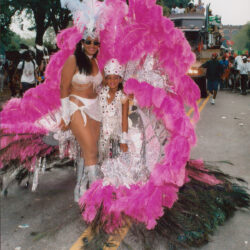 Woman and child in pink carnival feathers