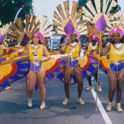 Carnival dancers in gold and purple costumes