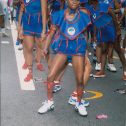 Children dancing in blue costumes at parade