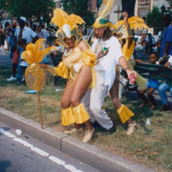 Carnival dancers in yellow feathered costumes