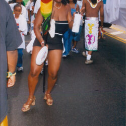 Smiling woman dancing in colorful street parade
