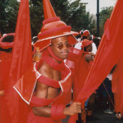 Man in red carnival costume with cone hat