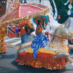 Woman in colorful costume on ornate parade float