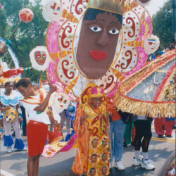Colorful giant mask costume in street parade