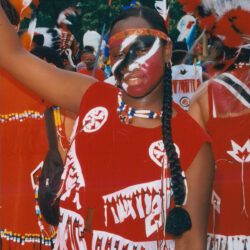 Person in red costume with painted face