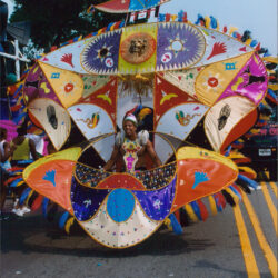 Person wearing large colorful carnival costume