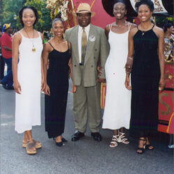 Group posing by parade float with giant bottle