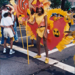 Woman in vibrant yellow-red carnival costume