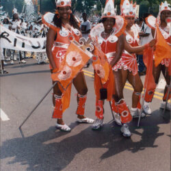 Group of dancers in orange carnival costumes