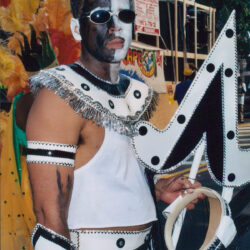 Face-painted carnival participant in black-and-white costume