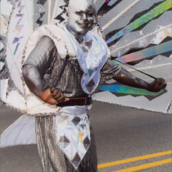 Parade performer in silver costume with wings