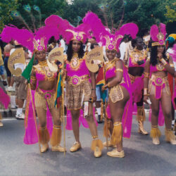 Women in pink and gold carnival parade costumes