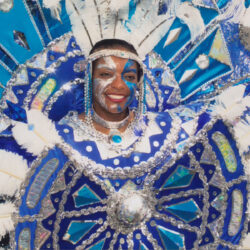 Smiling person in blue and white carnival costume