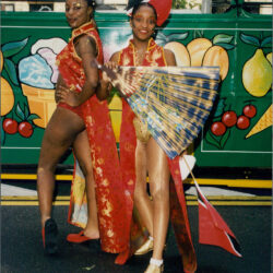 Two carnival dancers holding Trinidad and Tobago flag