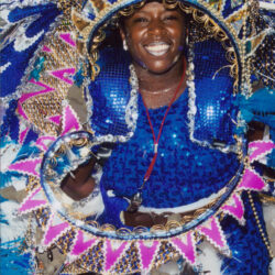 Smiling woman in blue sequined carnival costume