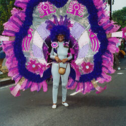 Person in large purple and pink carnival costume