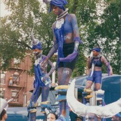 People on stilts in colorful costumes.