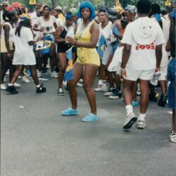 People celebrating at a colorful outdoor festival.