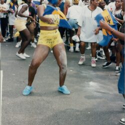 Person dancing at outdoor cultural festival.