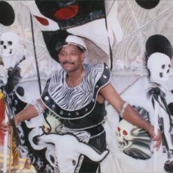Carnival performer in elaborate black and white costume.