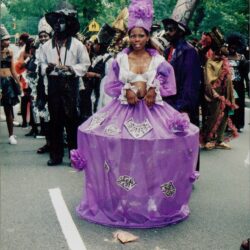 Person in purple costume at street parade.