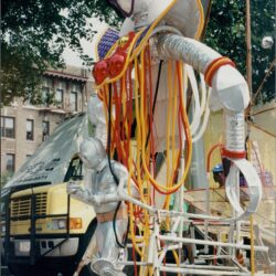 Large colorful robot sculpture on street display.