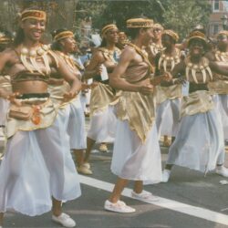 Dancers in festive costumes during street parade.