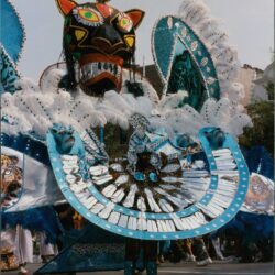 Colorful carnival costume with vibrant feathered headdress.