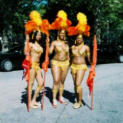 Three women in colorful carnival costumes.